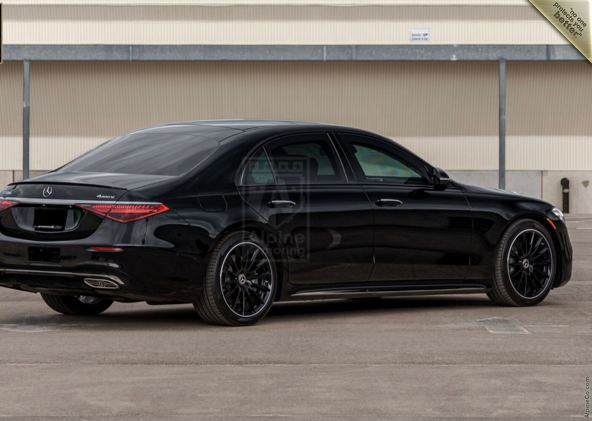 A black car parked in the parking lot