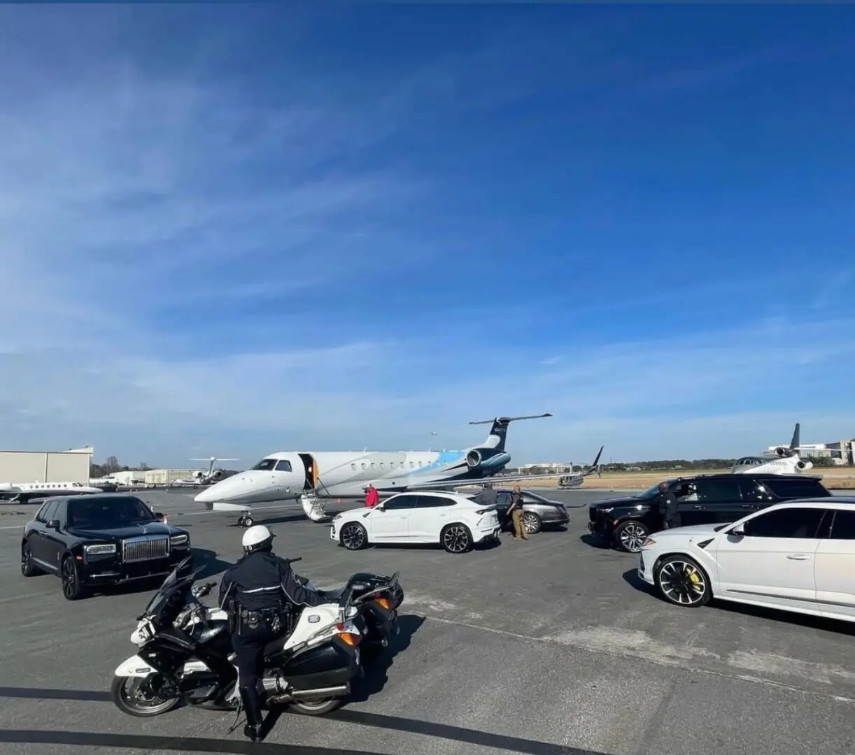 A motorcycle parked on the side of a runway.