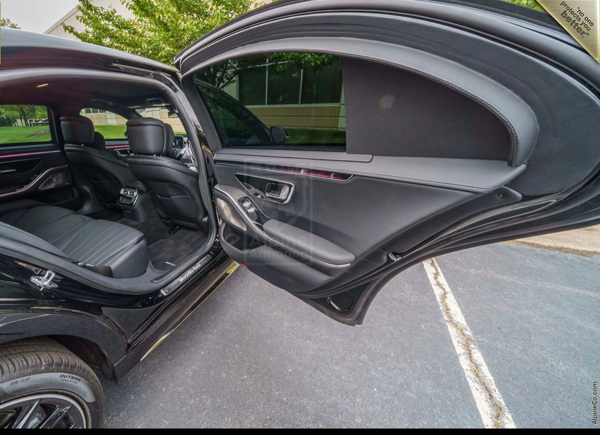 A car with the door open and the driver 's seat in view.