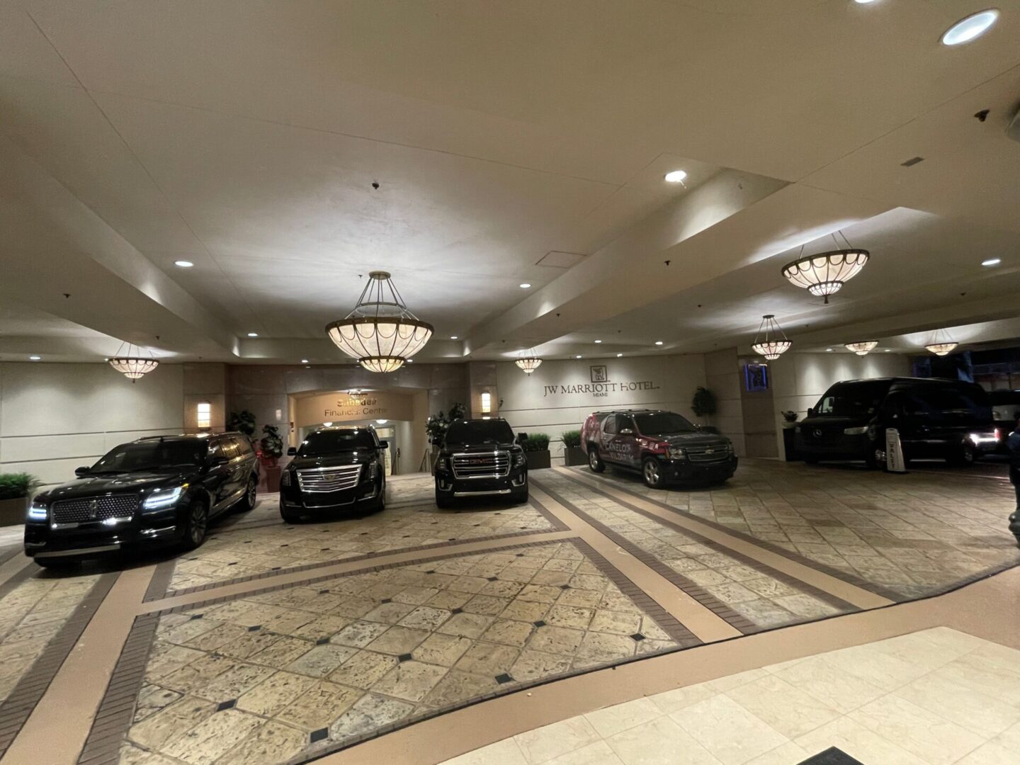 A large room with many cars parked in it