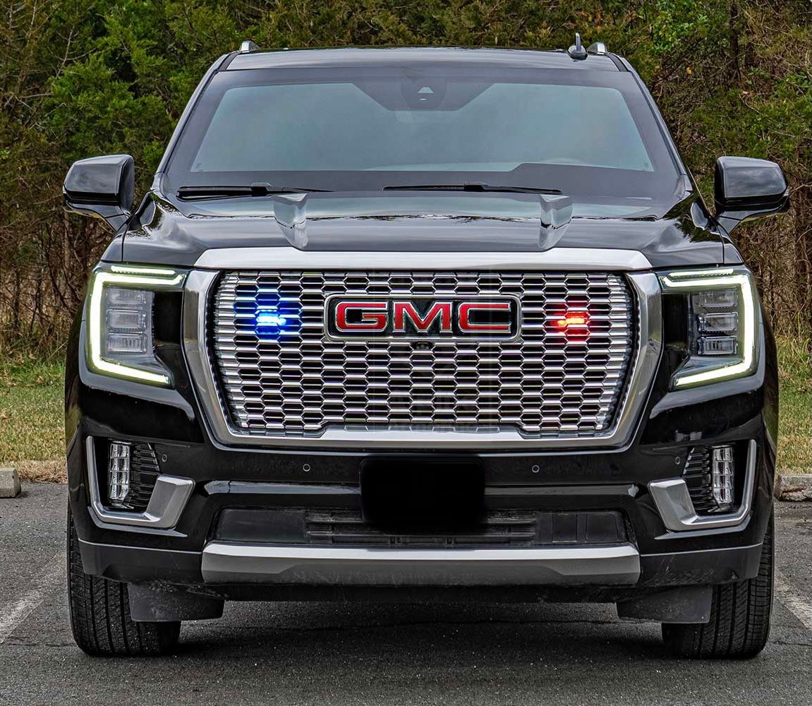 A black truck with two lights on the front.