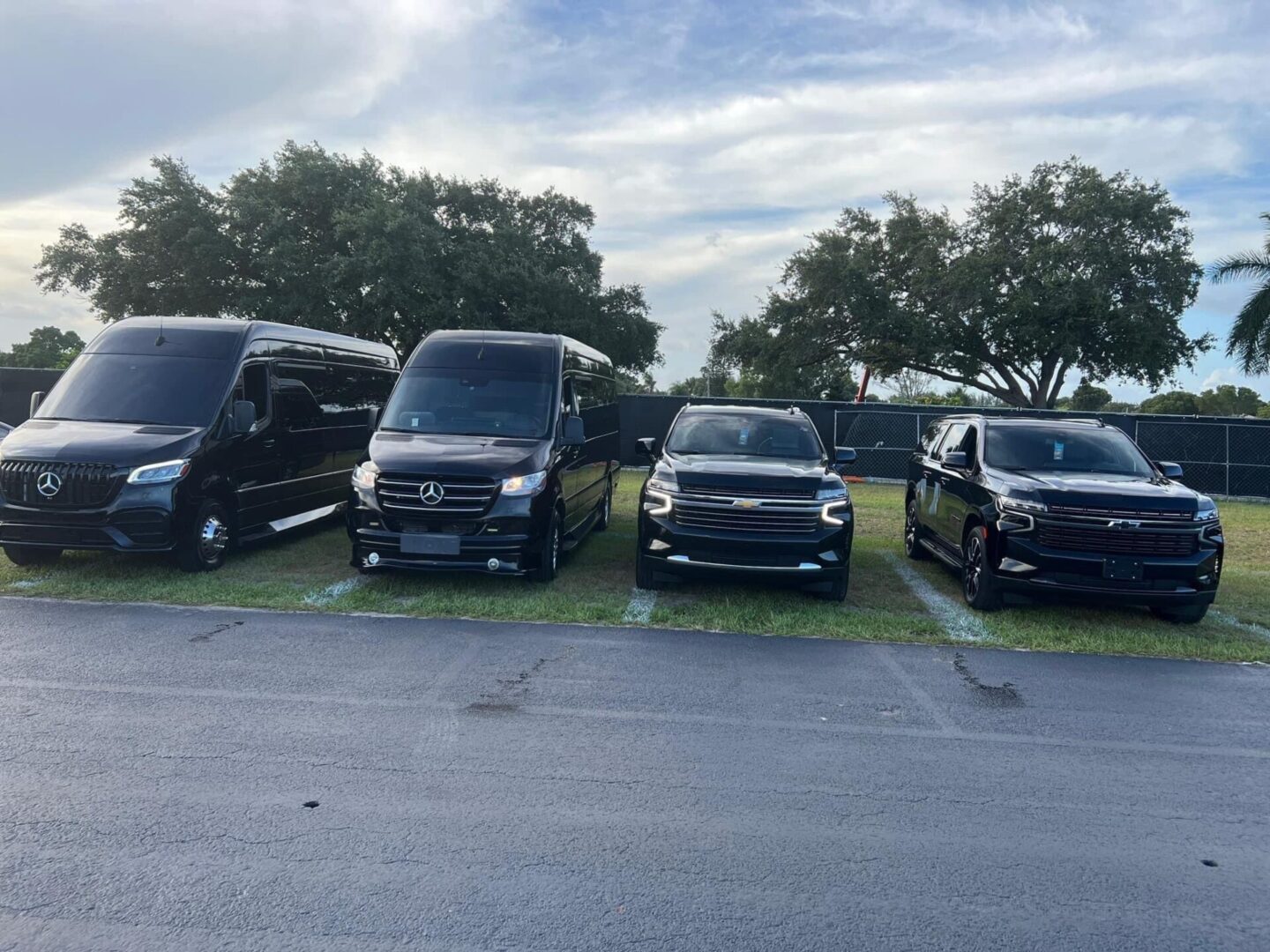 A group of vans parked in a parking lot.