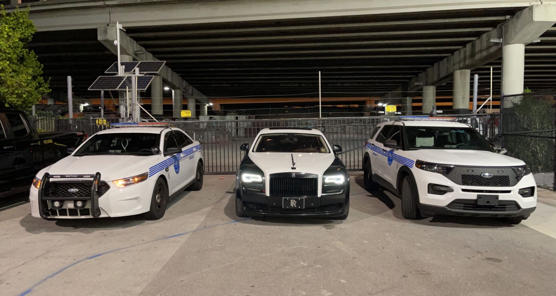 Three police cars parked in a parking lot.