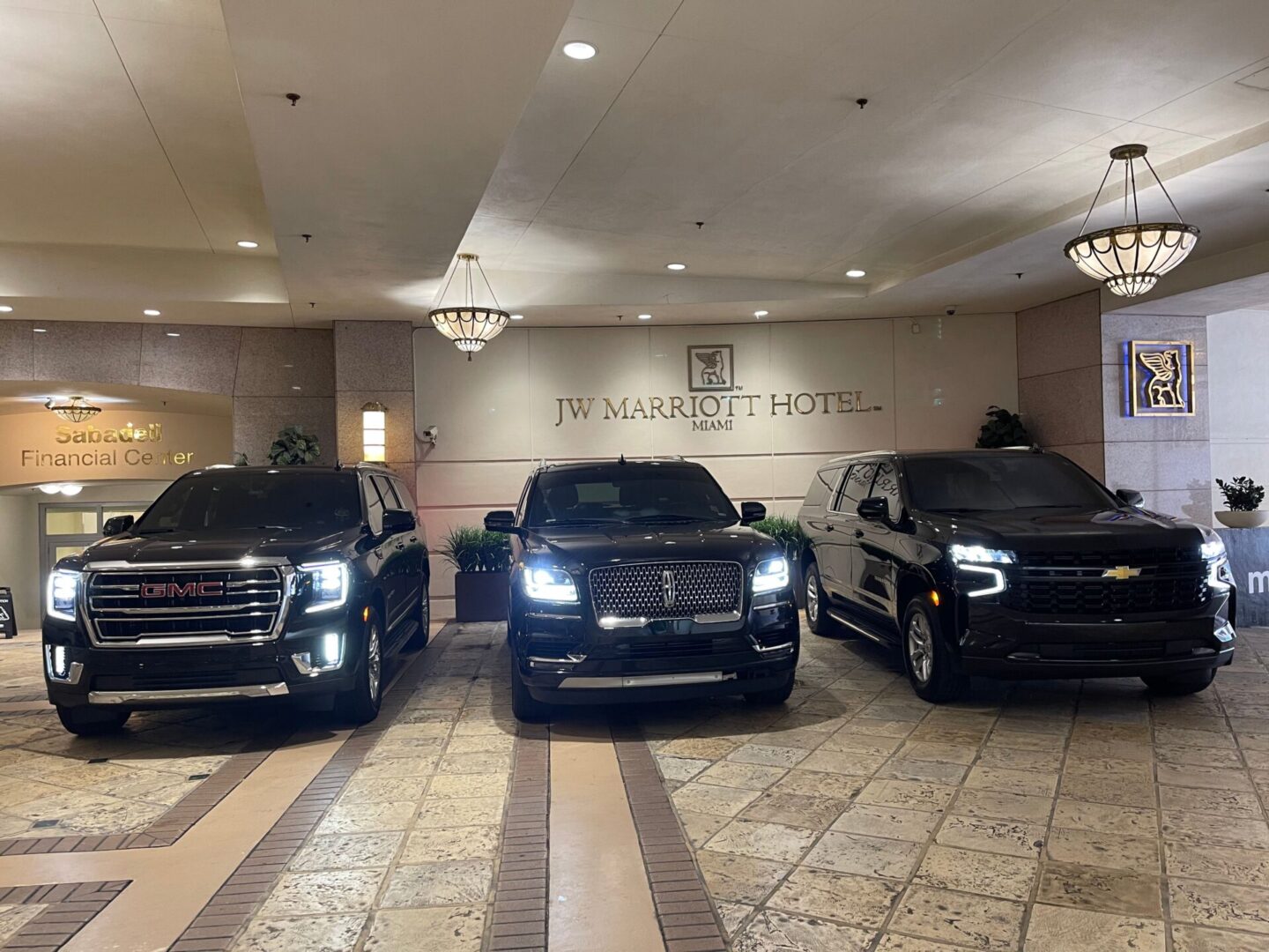 Three black trucks parked in a showroom.