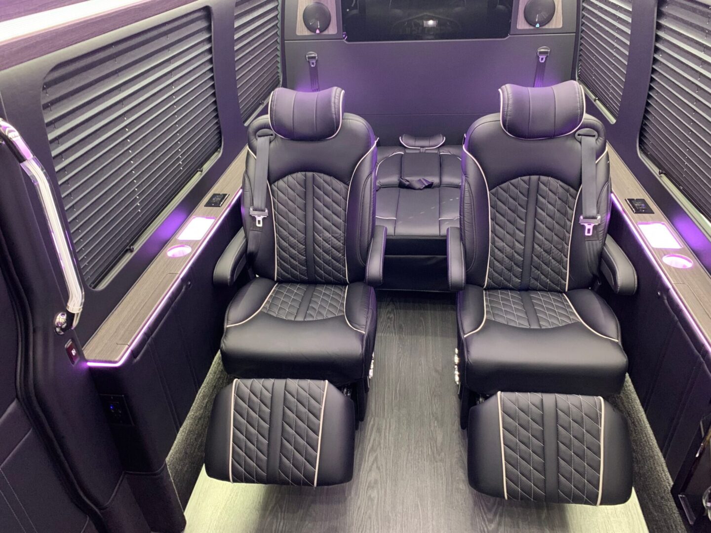 A coach bus with two seats and a table