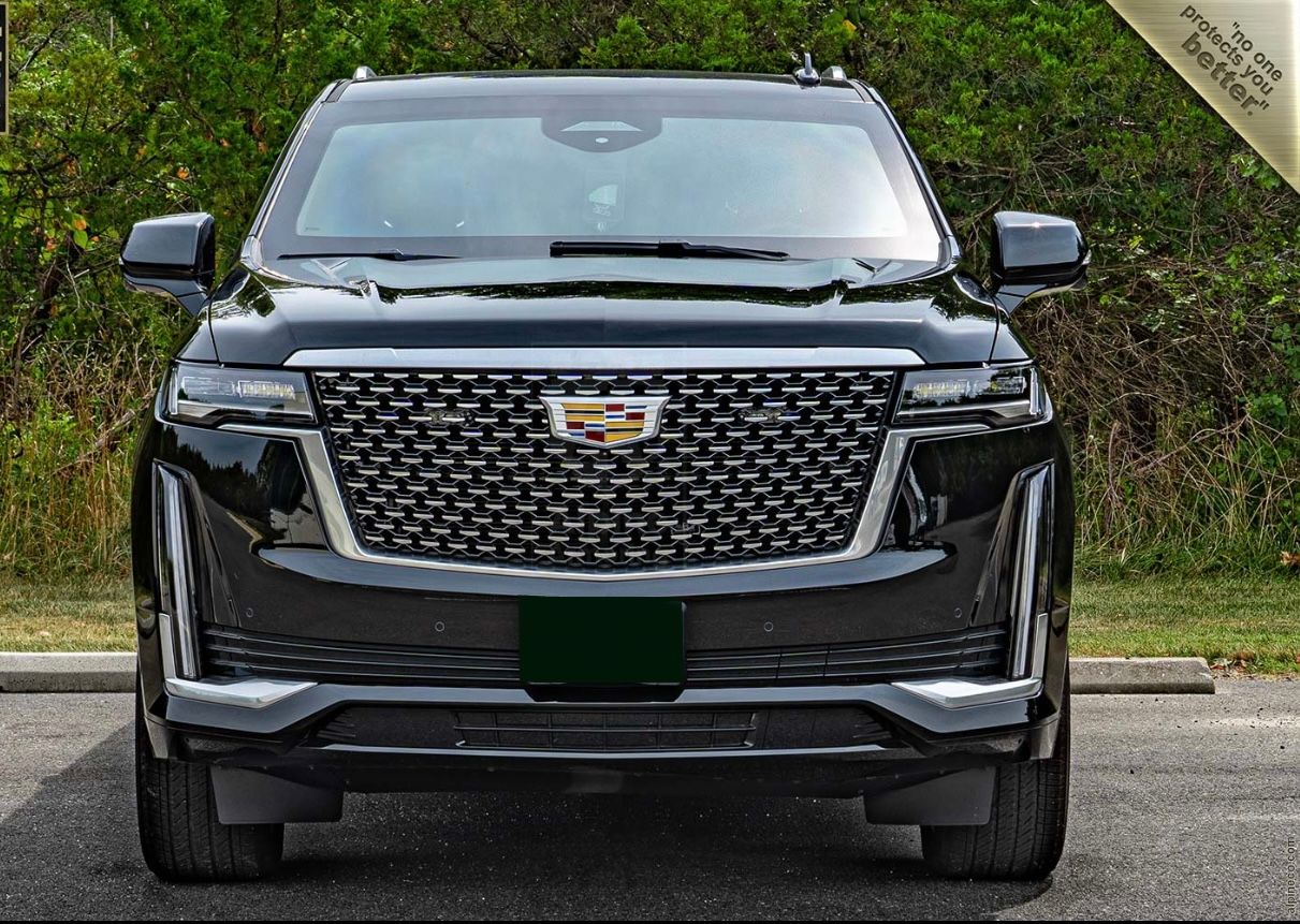 A black suv parked on the side of a road.