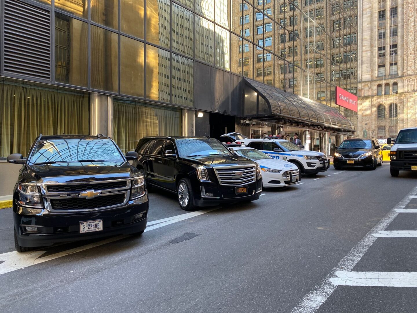 A street with many cars parked on the side of it