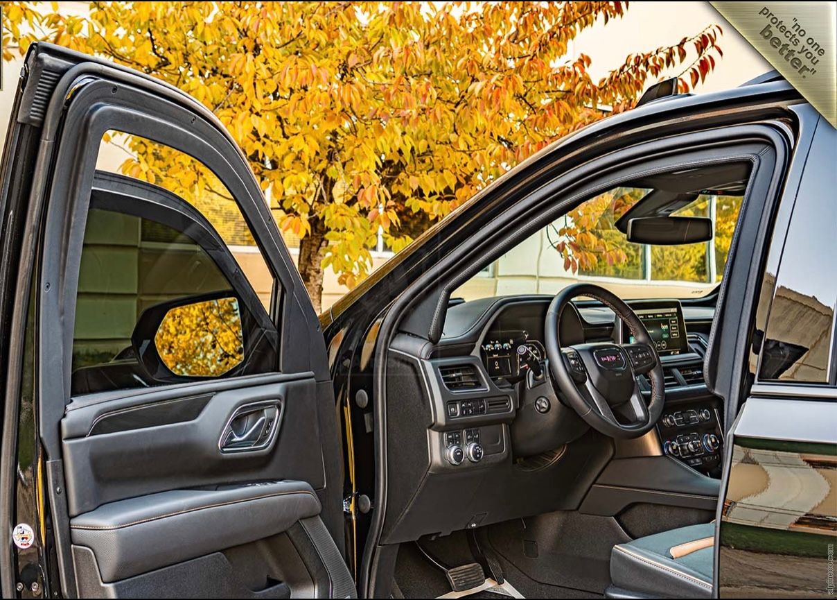 A car with the door open and the steering wheel in view.