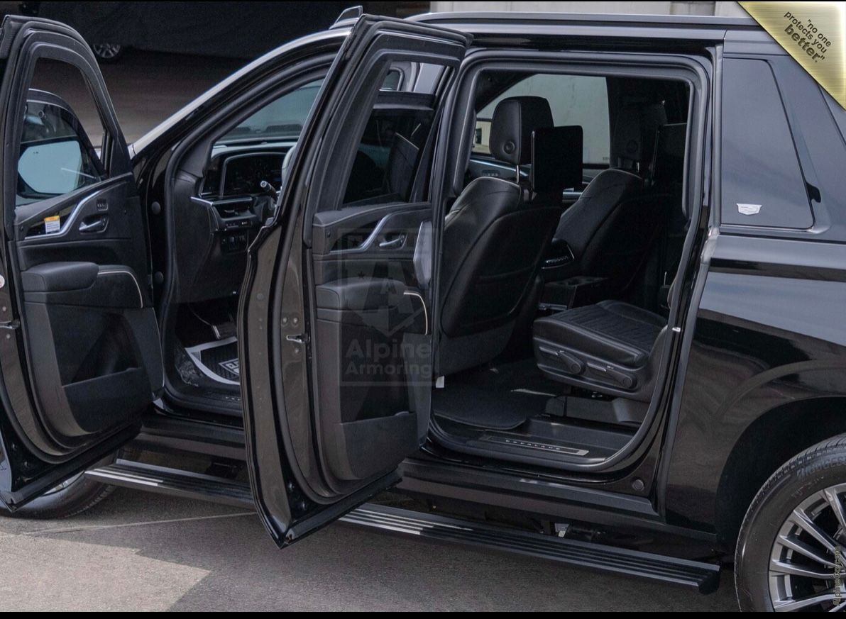 A black truck with its doors open.