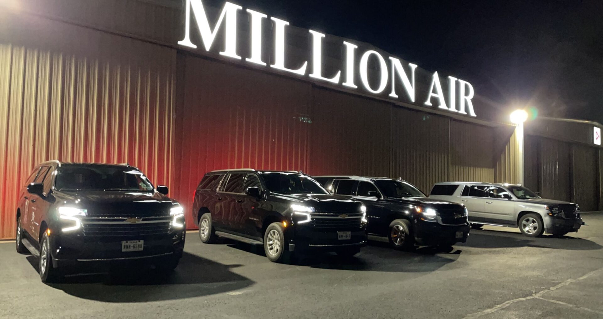 A group of cars parked in front of a building.