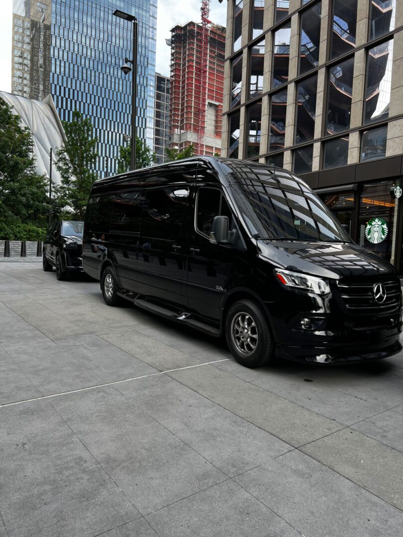 A black van parked on the side of a road.