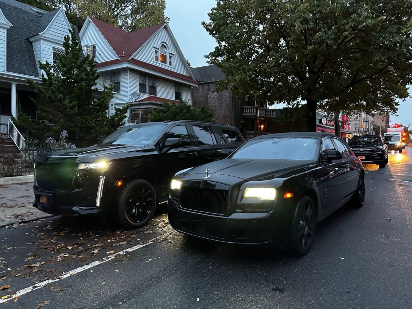 A couple of cars parked on the side of a road.