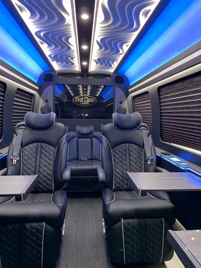 A bus with blue lights and black seats.