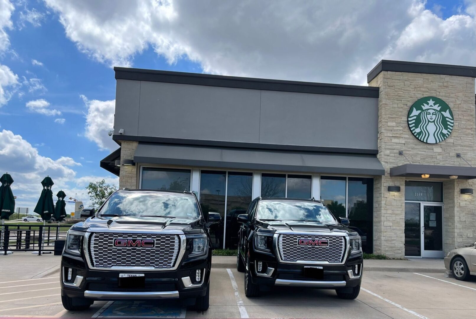 Two trucks parked in front of a building.