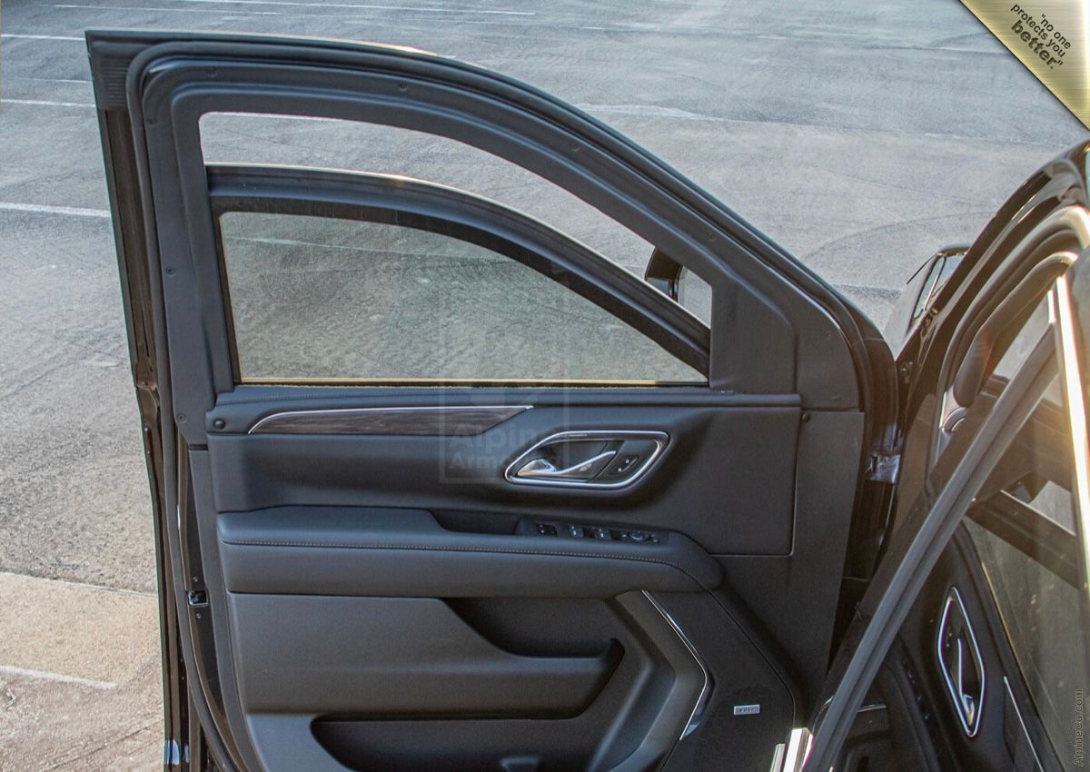 A car door open with the driver 's side view mirror on.