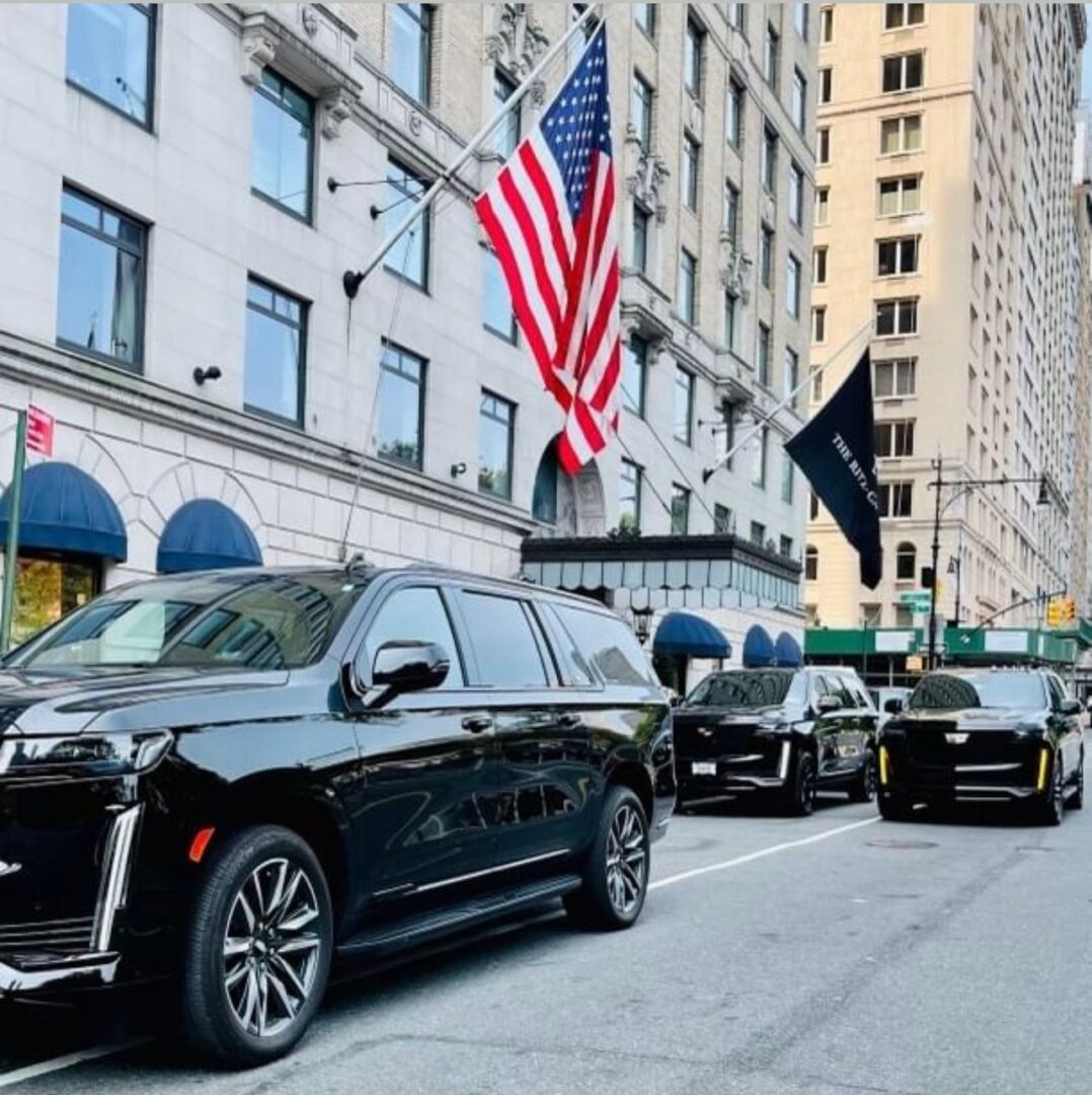 A line of cars parked on the side of a street.