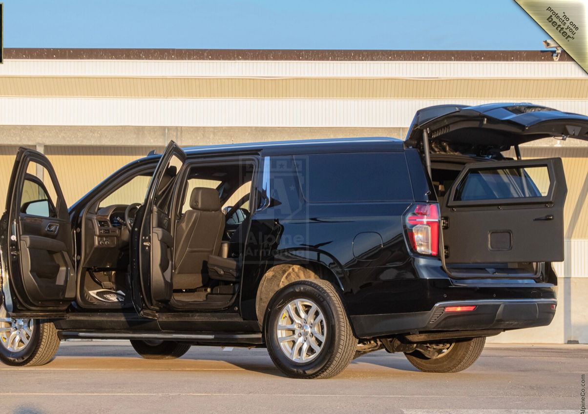 A black truck with its doors open and the back door opened.