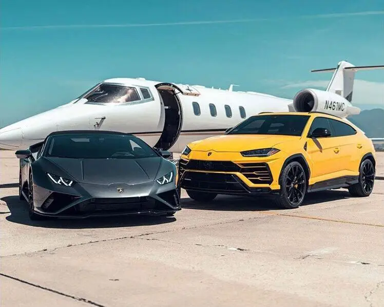 A yellow lamborghini parked next to another black car.