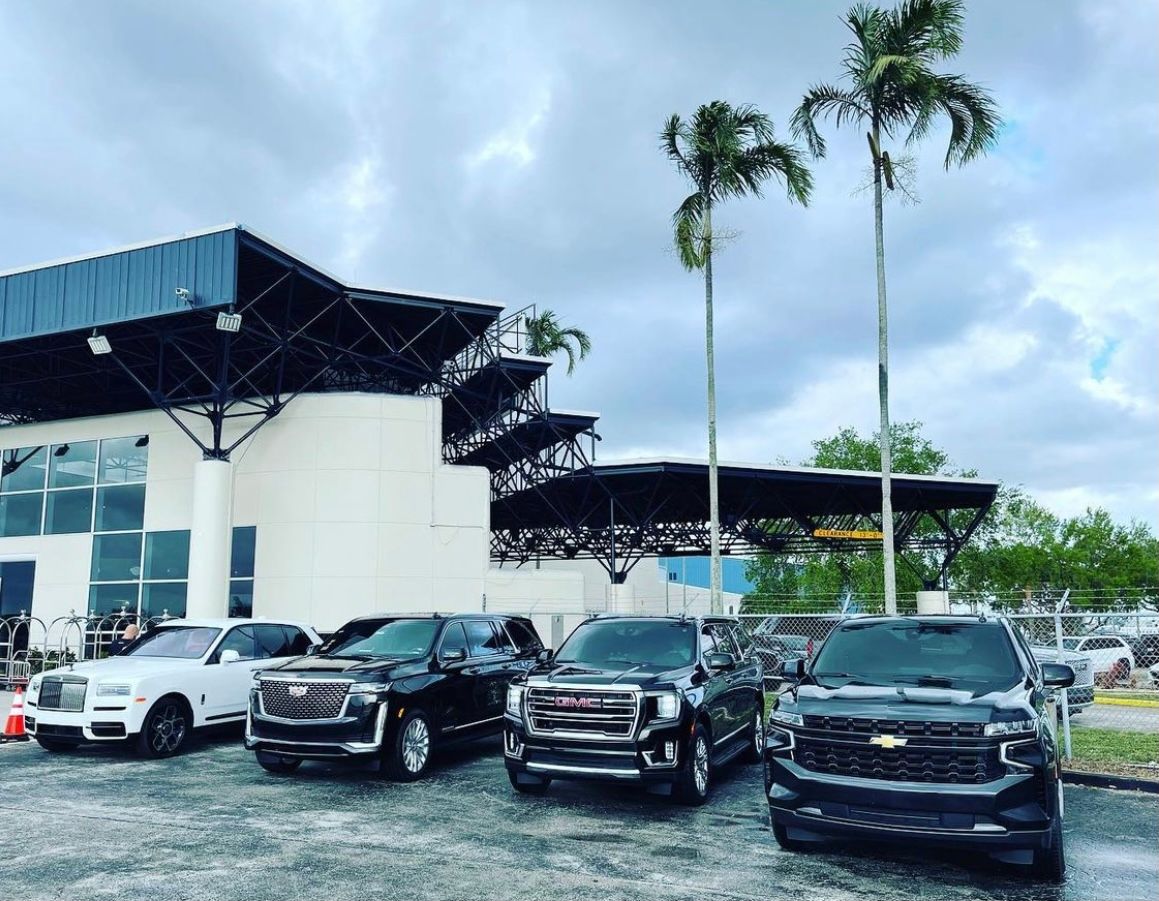 A group of trucks parked in front of a building.