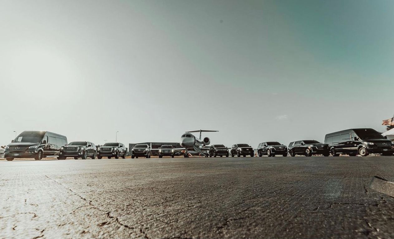 A large group of cars parked on the side of a road.